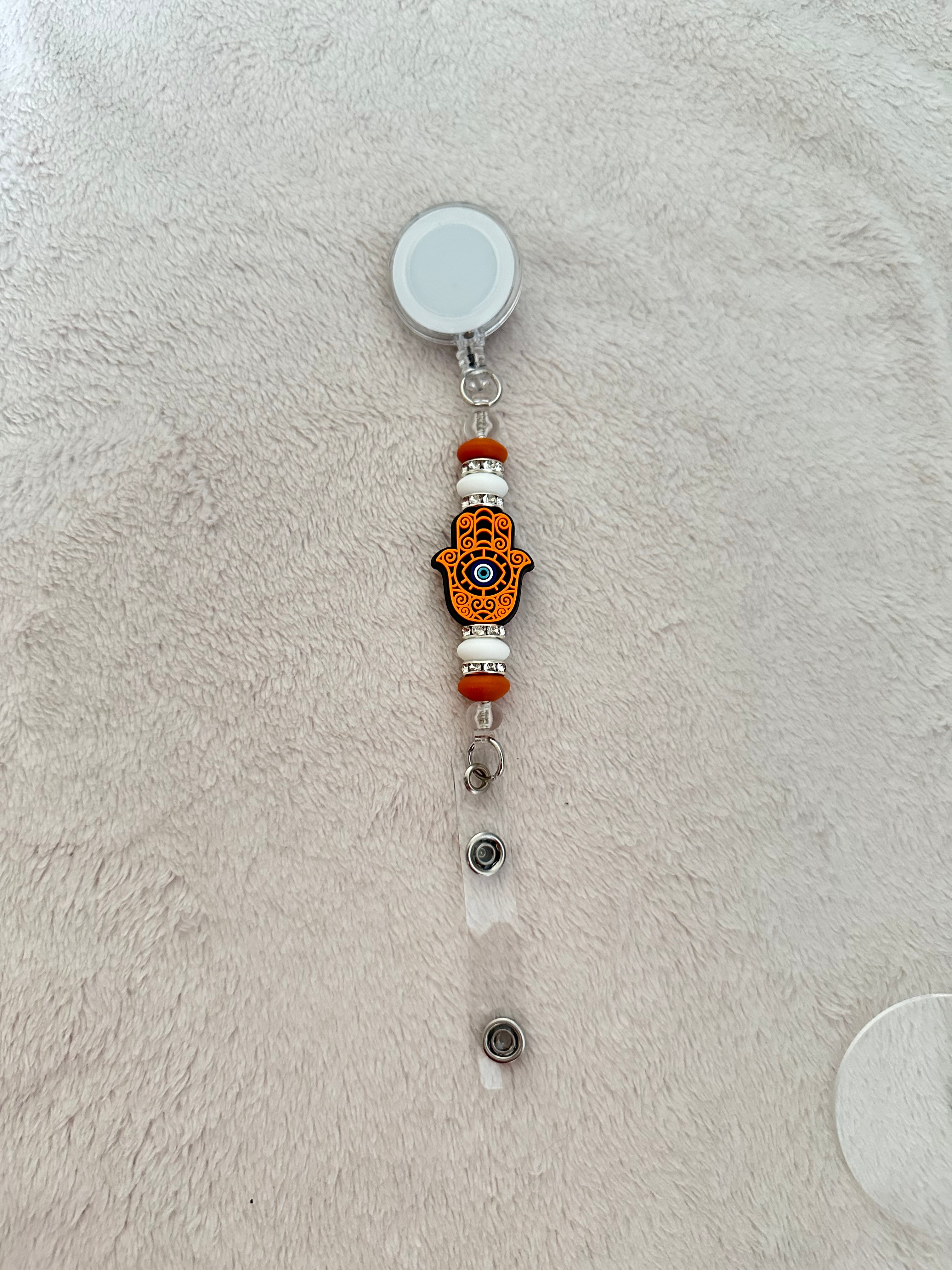 Evil eye retractable ID badge